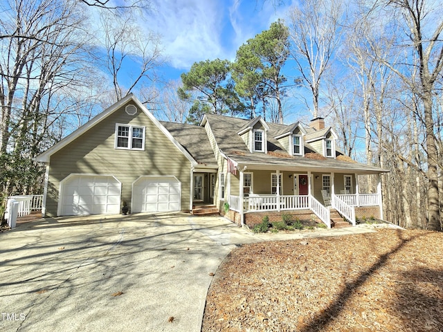 cape cod-style house featuring a garage and covered porch