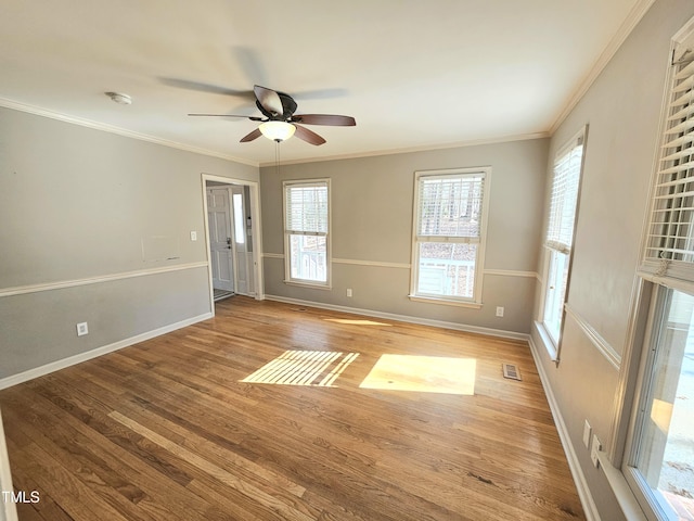 unfurnished room featuring ornamental molding, ceiling fan, and light wood-type flooring