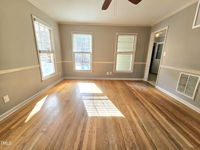 unfurnished room with ornamental molding, ceiling fan, and light wood-type flooring