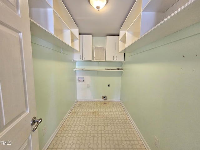 laundry area with cabinets, hookup for a washing machine, and hookup for an electric dryer