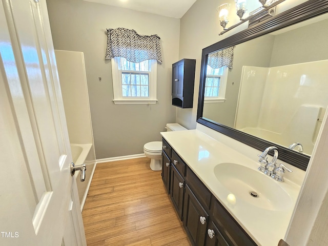 full bathroom featuring hardwood / wood-style flooring, vanity, plenty of natural light, and toilet