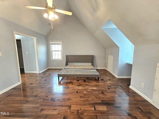 unfurnished bedroom featuring lofted ceiling, dark hardwood / wood-style floors, and ceiling fan