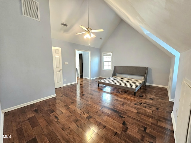 interior space featuring ceiling fan, dark hardwood / wood-style floors, high vaulted ceiling, and a skylight