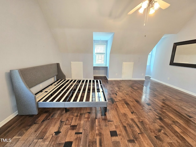 unfurnished bedroom with lofted ceiling, dark hardwood / wood-style floors, and ceiling fan