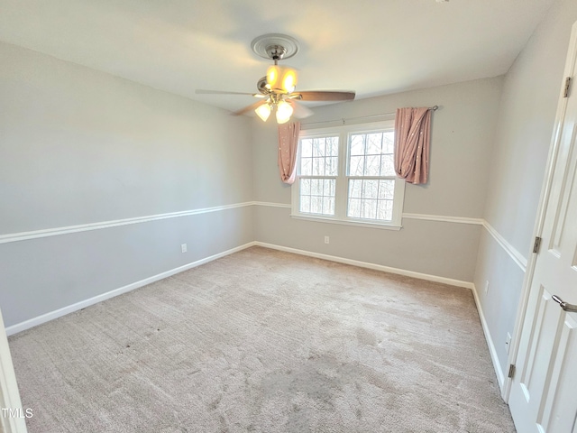 empty room featuring ceiling fan and light colored carpet