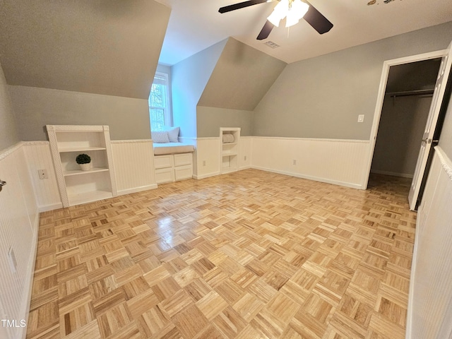 additional living space with light parquet flooring, vaulted ceiling, and ceiling fan