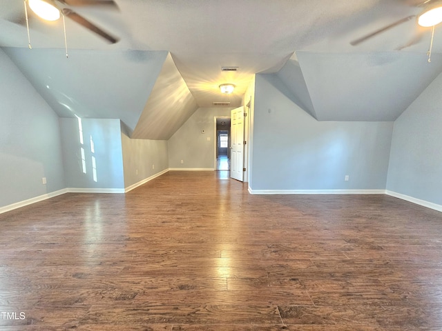 additional living space featuring dark wood-type flooring, ceiling fan, and vaulted ceiling