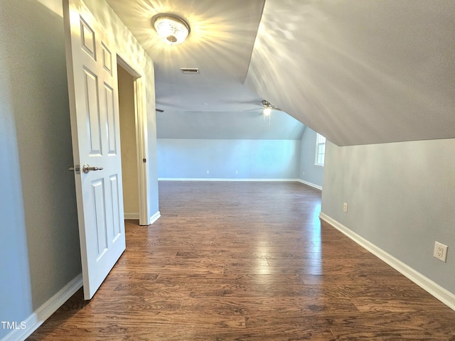 additional living space featuring dark hardwood / wood-style floors and vaulted ceiling