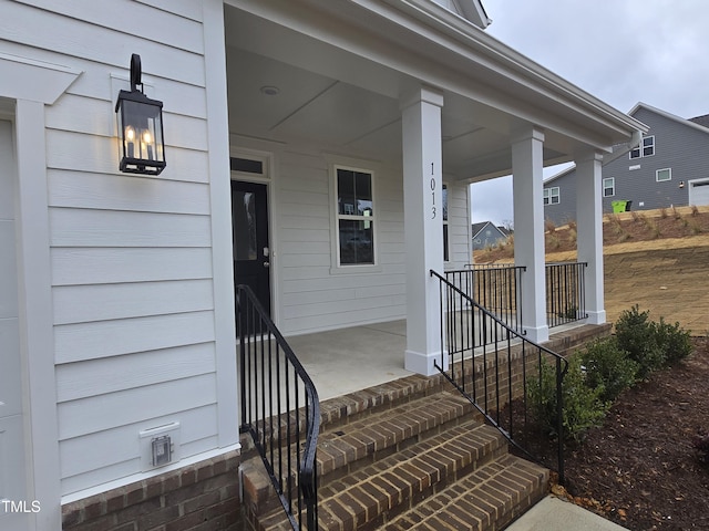 entrance to property featuring a porch