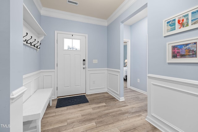 mudroom with ornamental molding and light wood-type flooring