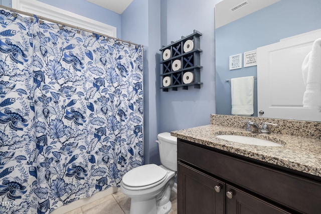 bathroom with vanity, tile patterned floors, and toilet