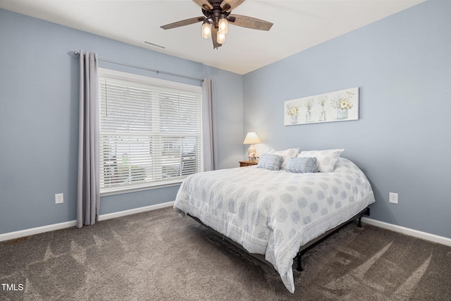 bedroom with ceiling fan and dark colored carpet