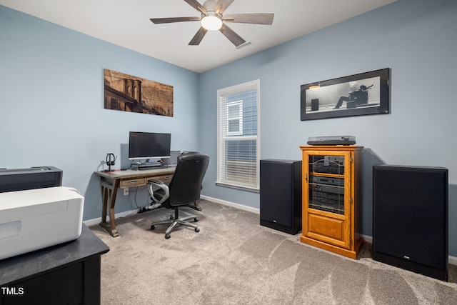 carpeted office space with ceiling fan