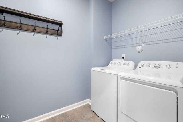 laundry room featuring light tile patterned floors and washer and clothes dryer