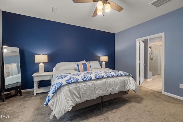 bedroom with ceiling fan, connected bathroom, and carpet