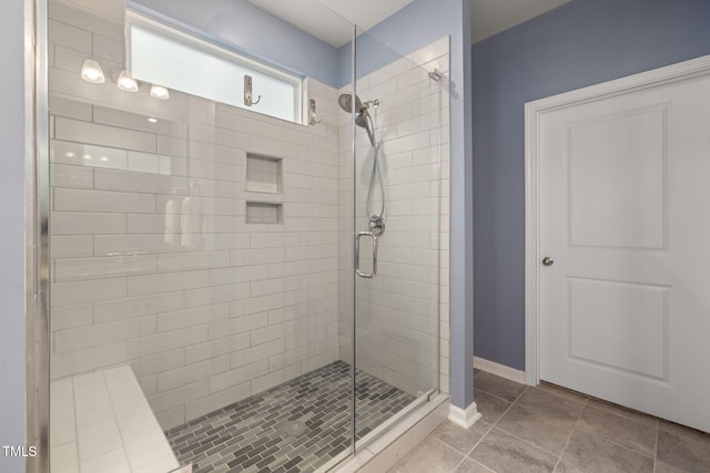 bathroom with tile patterned flooring and a shower with shower door