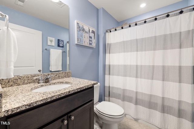 bathroom featuring vanity, curtained shower, and toilet