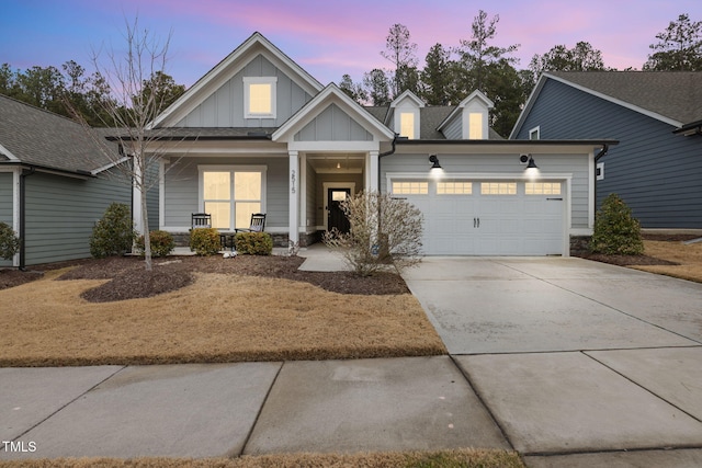 view of front of home with a garage and a porch