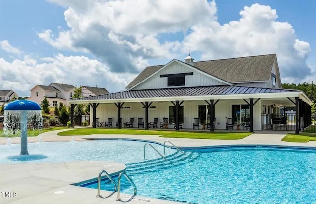 view of swimming pool with a patio and pool water feature