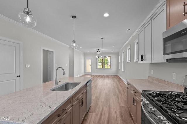 4522 Sweet Williams Ln Unit 163, Wilson, NC 27896 - kitchen with sink, hanging light fixtures, stainless steel appliances, light stone counters, and ornamental molding