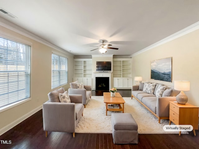 living room featuring crown molding, dark hardwood / wood-style floors, ceiling fan, and built in shelves