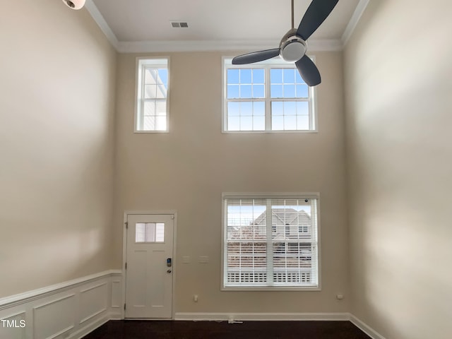 entrance foyer with crown molding, ceiling fan, and plenty of natural light