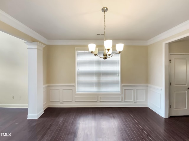 unfurnished dining area with decorative columns, crown molding, dark hardwood / wood-style floors, and an inviting chandelier