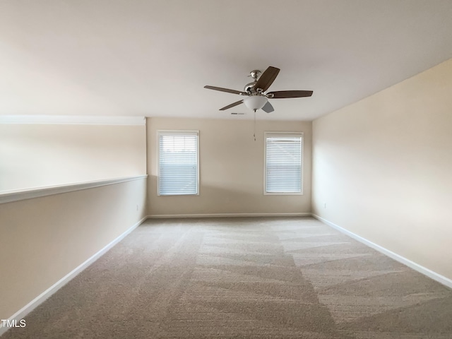 unfurnished room featuring light carpet and ceiling fan