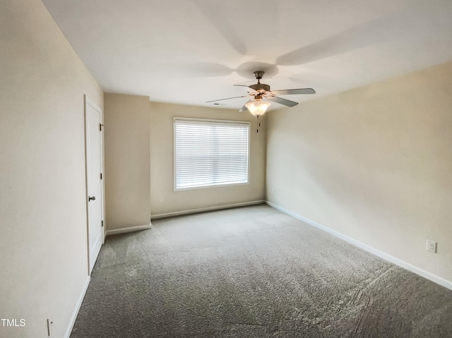 carpeted empty room featuring ceiling fan