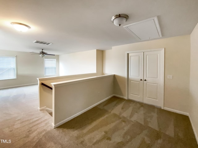 corridor with light colored carpet