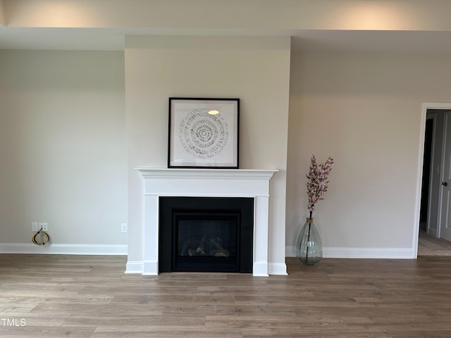 unfurnished living room featuring hardwood / wood-style flooring