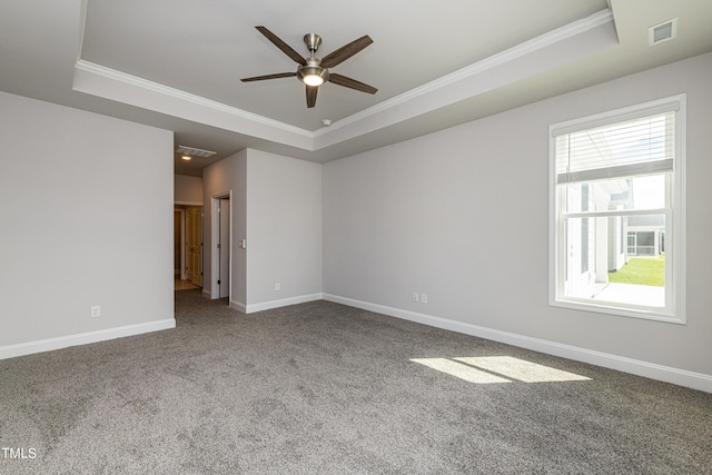 unfurnished room featuring visible vents, crown molding, a tray ceiling, and a ceiling fan
