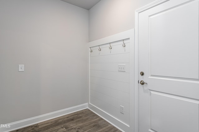 mudroom with baseboards and dark wood-type flooring