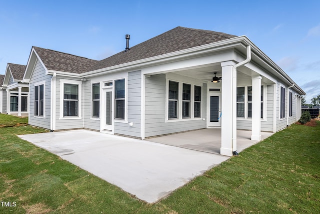 back of house with a patio, a ceiling fan, and roof with shingles