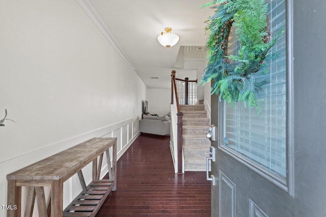 interior space with dark hardwood / wood-style flooring and ornamental molding