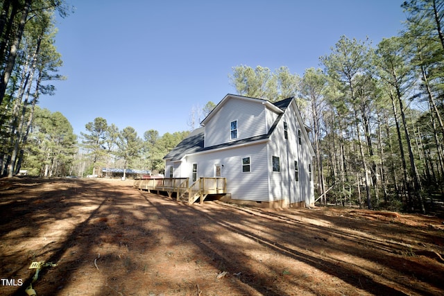 view of property exterior featuring a wooden deck