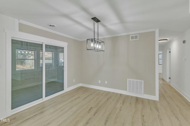 unfurnished dining area featuring ornamental molding and light hardwood / wood-style floors