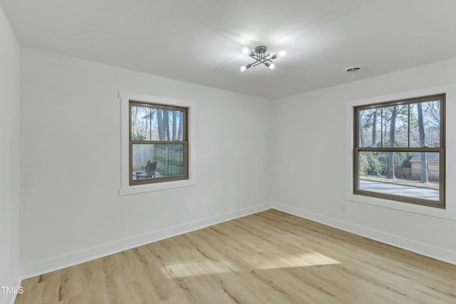 unfurnished room with a wealth of natural light and light wood-type flooring