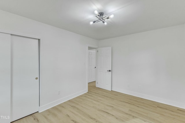 unfurnished bedroom featuring a closet and light wood-type flooring