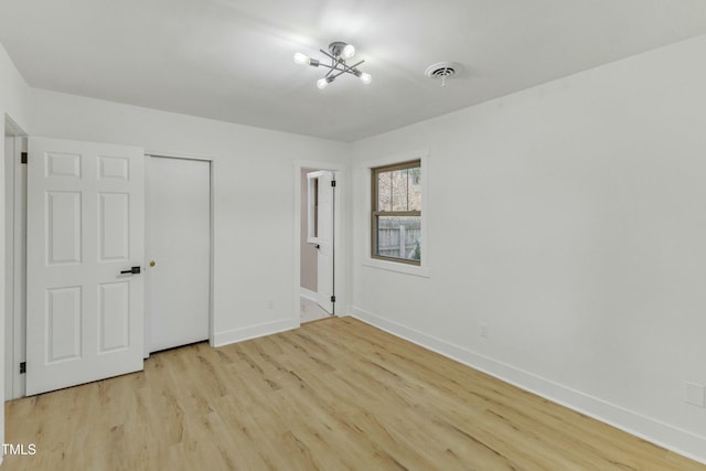 unfurnished bedroom featuring light hardwood / wood-style floors and a closet