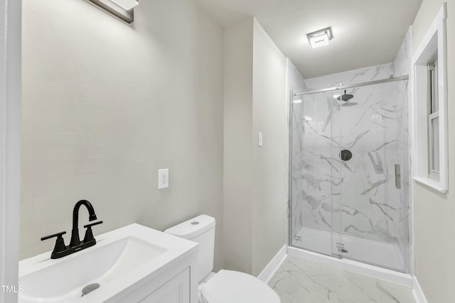 bathroom featuring vanity, toilet, and a shower with shower door