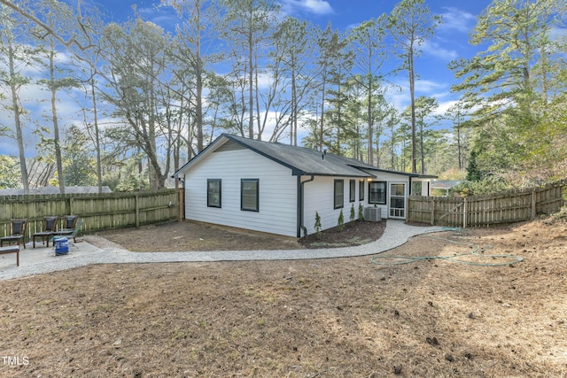 rear view of house with central AC and a patio