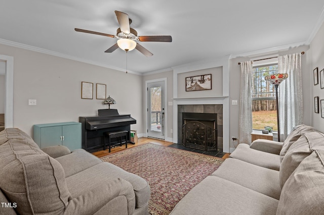 100 Churchill Rd, Louisburg, NC 27549 - living room featuring baseboards, ornamental molding, ceiling fan, a tile fireplace, and wood finished floors