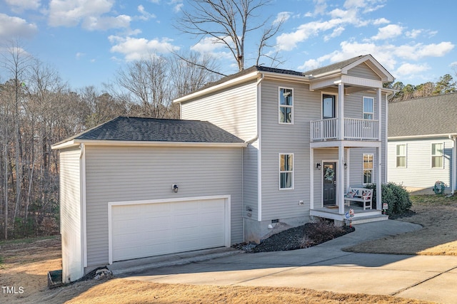 front facade featuring a garage and a balcony