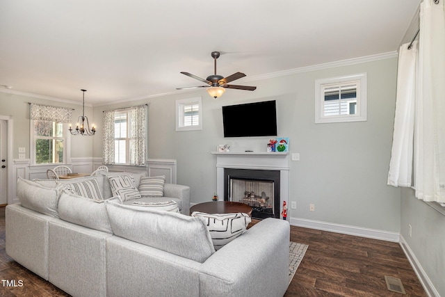 living room featuring ornamental molding, ceiling fan with notable chandelier, and dark hardwood / wood-style flooring