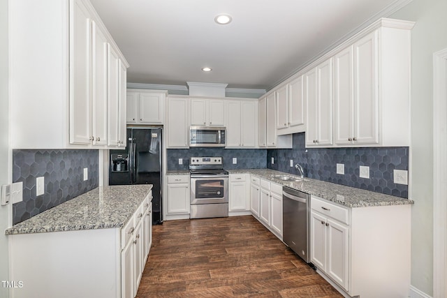 kitchen featuring light stone counters, sink, stainless steel appliances, and white cabinets