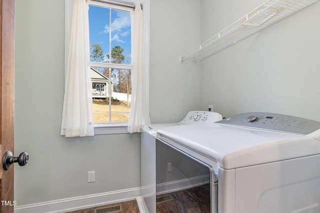 laundry area featuring wood-type flooring and separate washer and dryer