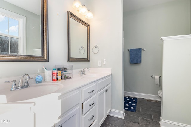 bathroom with tile patterned floors, vanity, and toilet