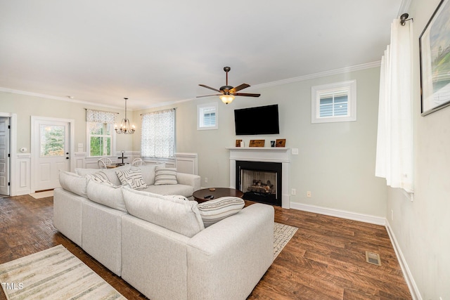 living room with crown molding, ceiling fan with notable chandelier, and dark hardwood / wood-style flooring