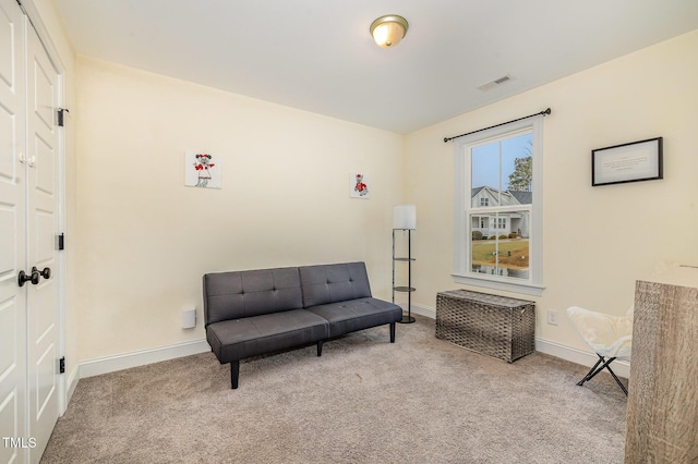 sitting room featuring light carpet